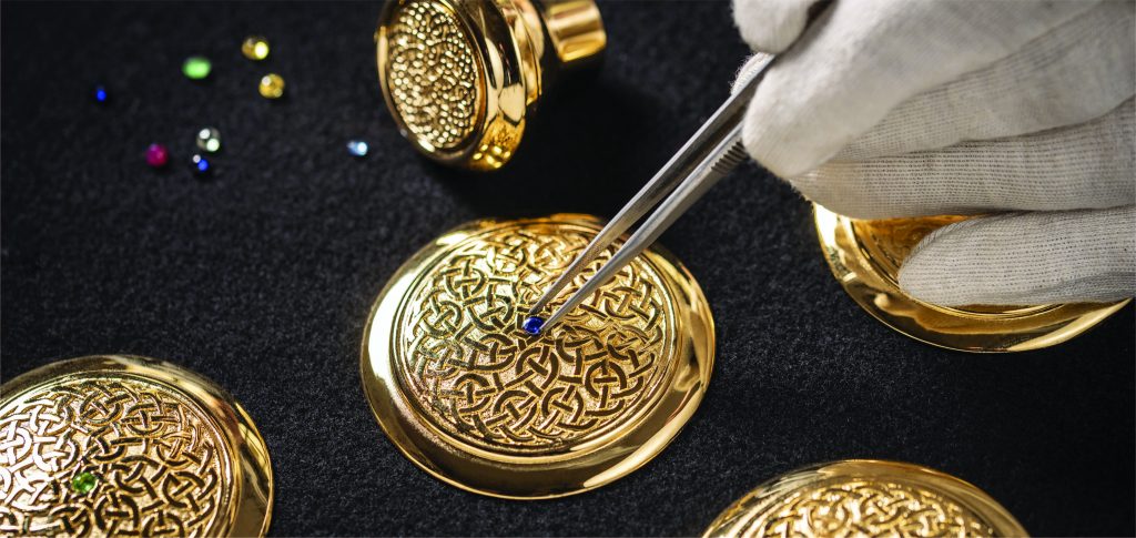 Setting a precious jewel into a gold ornate shield